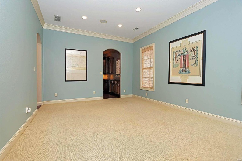 Carpeted spare room featuring ornamental molding