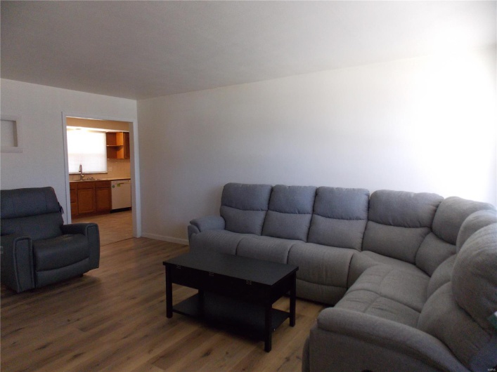 Living area featuring light wood-style flooring and baseboards