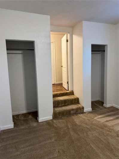 Unfurnished bedroom featuring carpet and baseboards