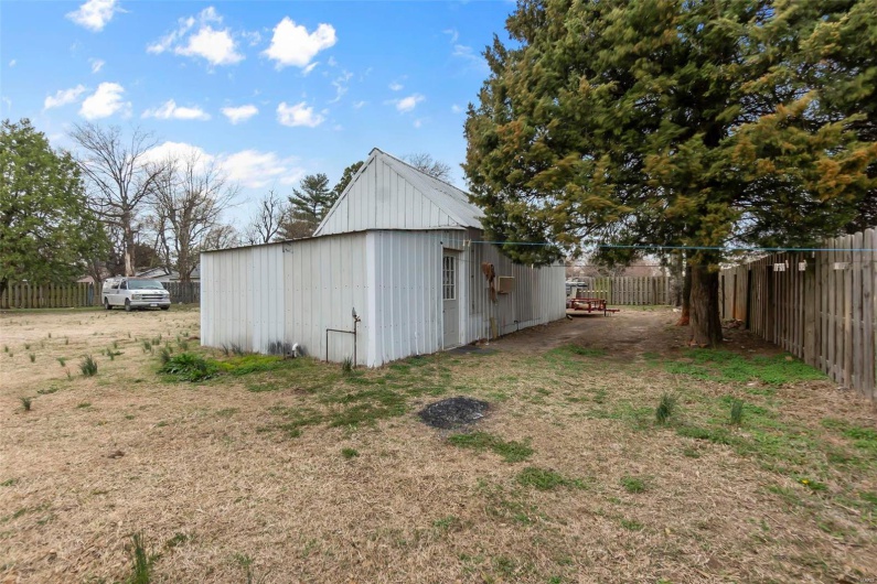 View of pole building featuring fence
