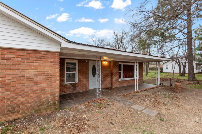 Doorway to property featuring brick siding
