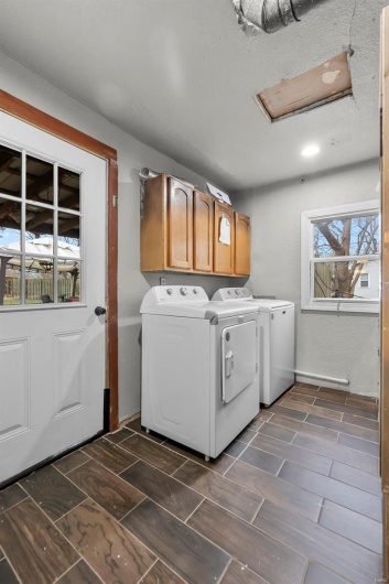 Laundry room featuring cabinet space and washing machine and clothes dryer
