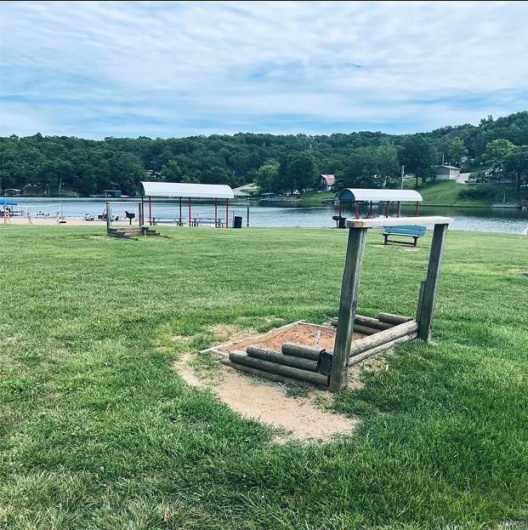 View of property's community featuring a yard and a water view