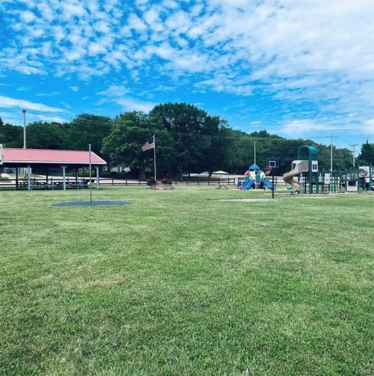 Surrounding community featuring a lawn and playground community