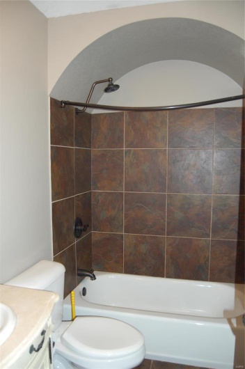 Full bathroom with tub / shower combination, toilet, and vanity