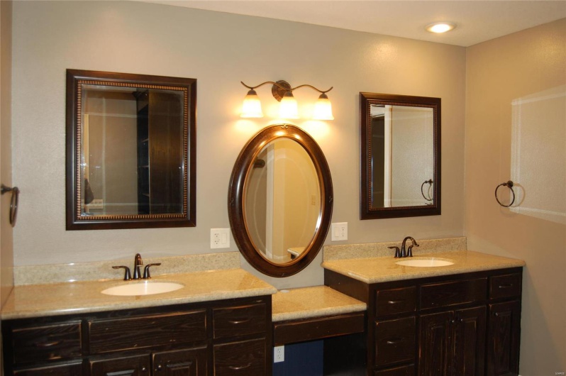 Full bathroom with two vanities and a sink
