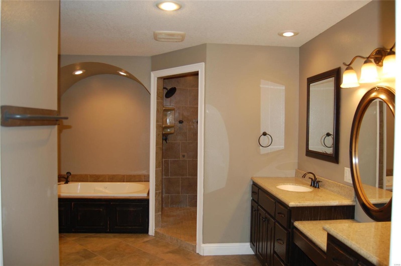 Full bathroom featuring vanity, baseboards, recessed lighting, a tile shower, and a garden tub