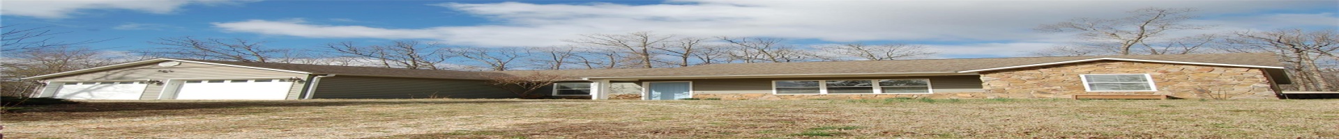 Residential For Sale Single story home with stone siding, a front lawn, a shingled roof, and a garage