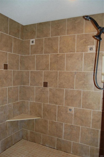 Full bath with a tile shower