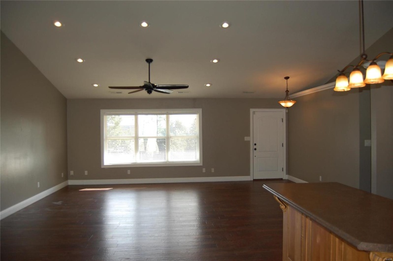 Unfurnished living room featuring dark wood-style floors, recessed lighting, baseboards, and ceiling fan