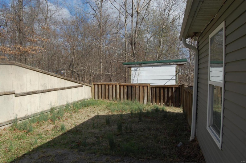 View of yard with an outbuilding and fence