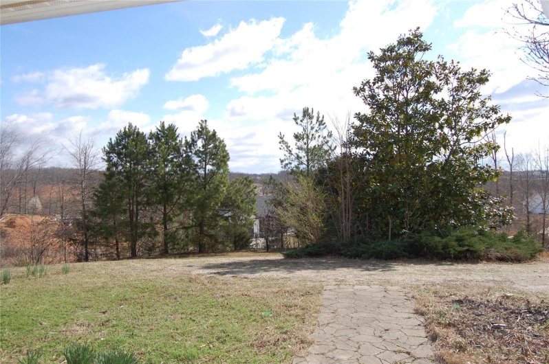 View of yard featuring a forest view