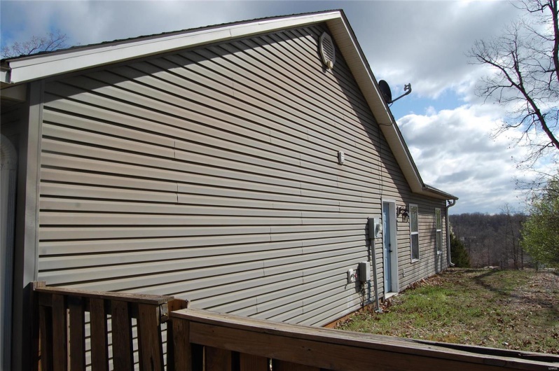 View of side of property featuring fence