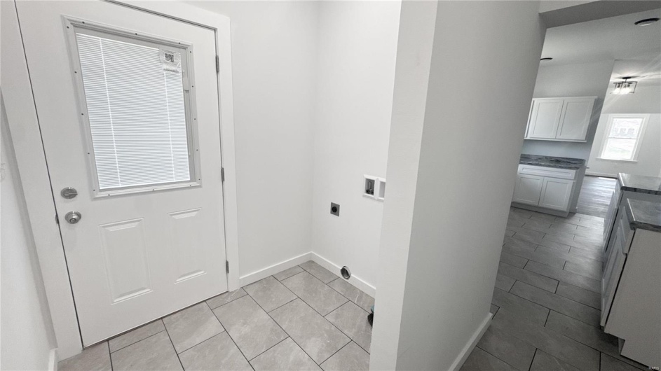 Laundry room featuring washer hookup, baseboards, laundry area, electric dryer hookup, and light tile patterned floors