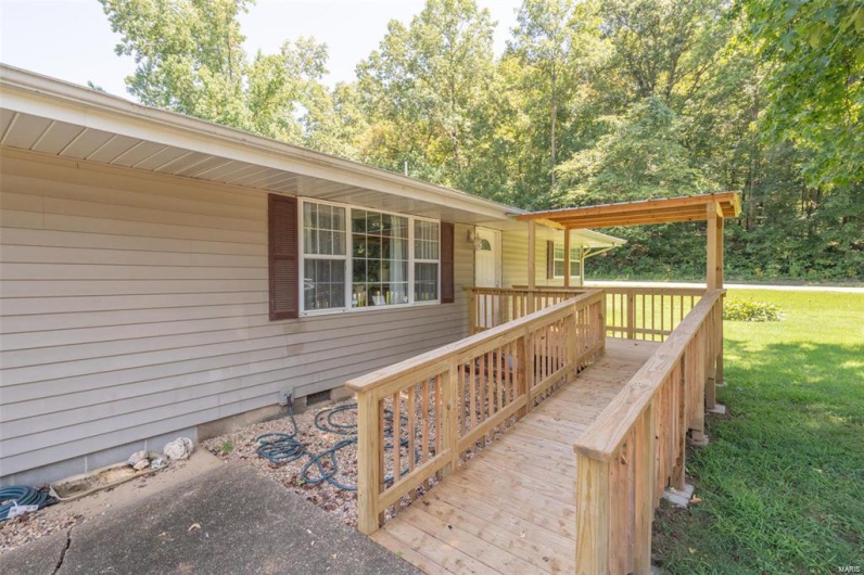 Wooden deck featuring a lawn