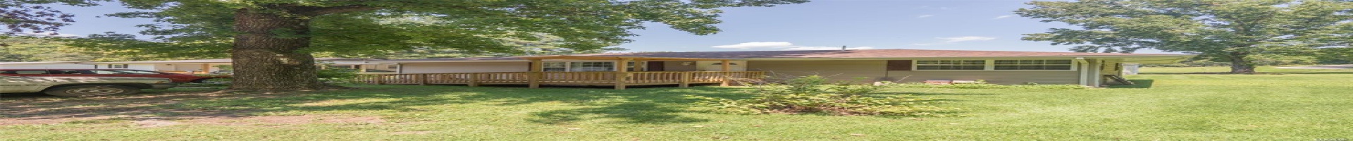 Residential For Sale View of front of home with a deck and a front lawn