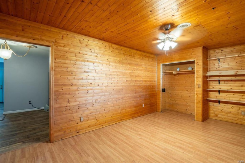 Unfurnished room with wood finished floors, ceiling fan, wooden ceiling, and wood walls