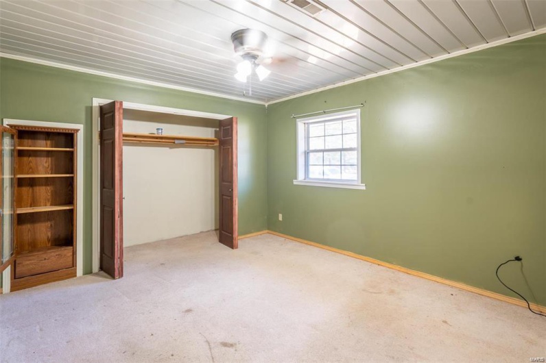 Unfurnished bedroom with visible vents, ornamental molding, a closet, carpet flooring, and baseboards