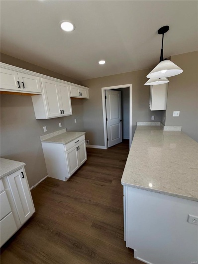 Kitchen featuring a peninsula, white cabinets, recessed lighting, and dark wood-style flooring