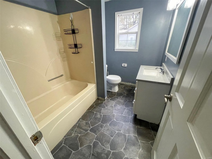 Full bathroom featuring vanity, bathing tub / shower combination, and toilet
