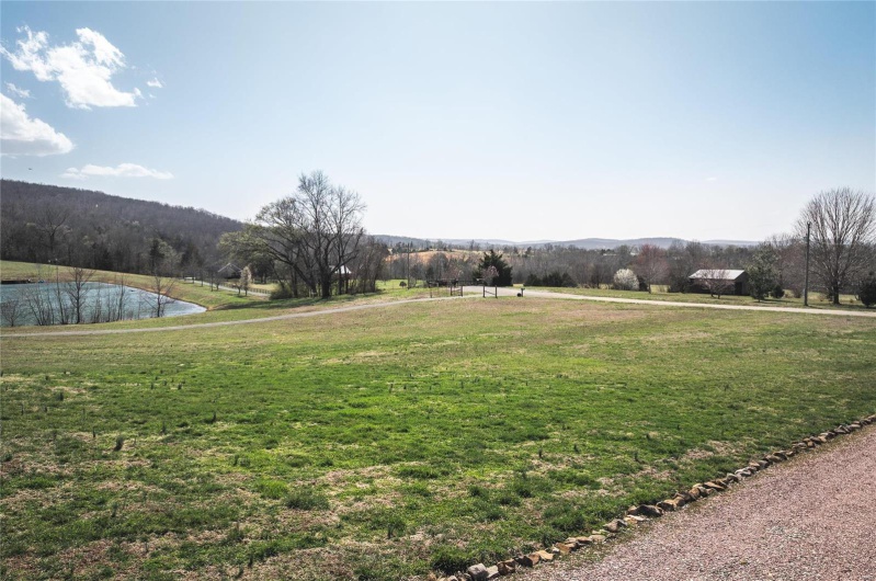 View of yard featuring a water and mountain view and a rural view