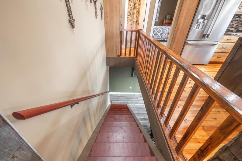 Staircase featuring wood finished floors