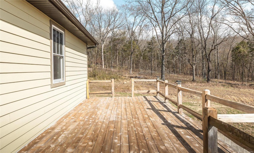 Deck featuring a wooded view