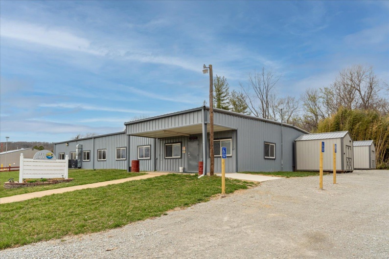View of front of home with an outbuilding and a front yard