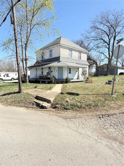 View of front of house with a porch and a front yard