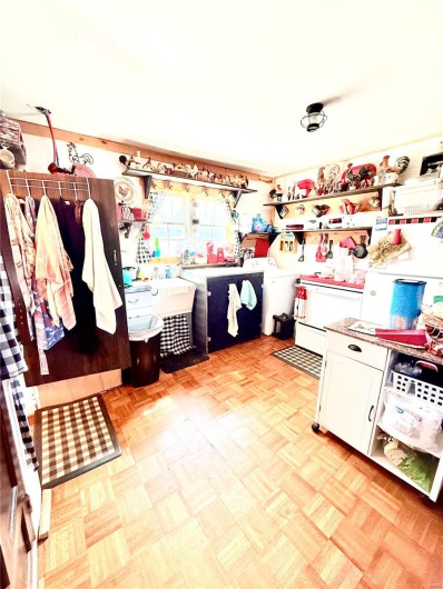 Kitchen with white cabinetry and washer / clothes dryer