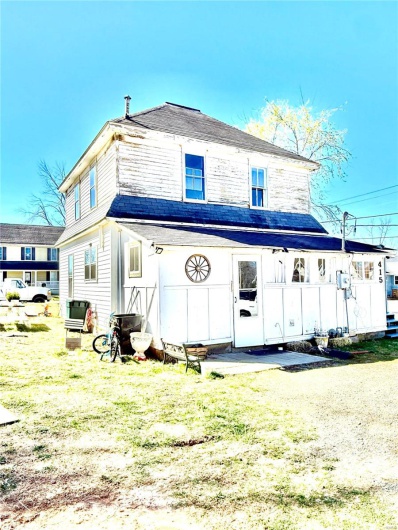 Rear view of property with a yard