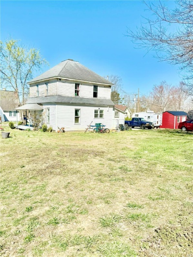 Rear view of property with a lawn