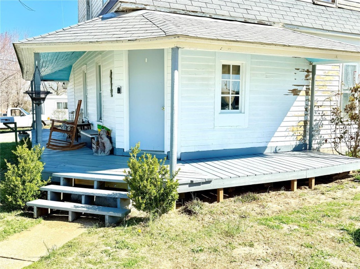 Doorway to property featuring a porch