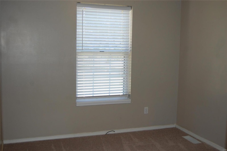 Empty room featuring carpet floors and baseboards