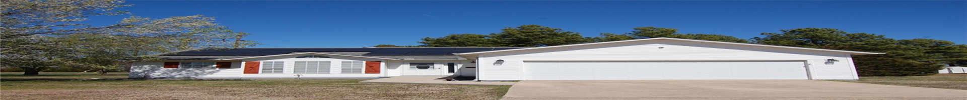 Residential For Sale Single story home featuring a front yard, roof with shingles, concrete driveway, an attached garage, and solar panels