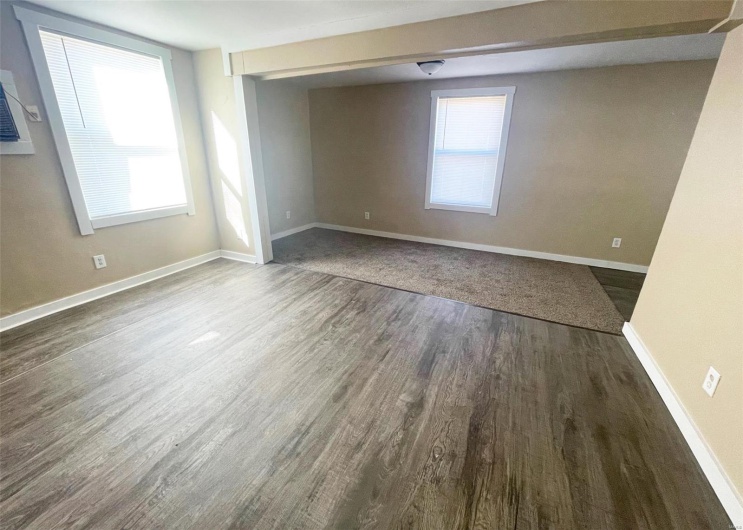Empty room with baseboards and wood finished floors