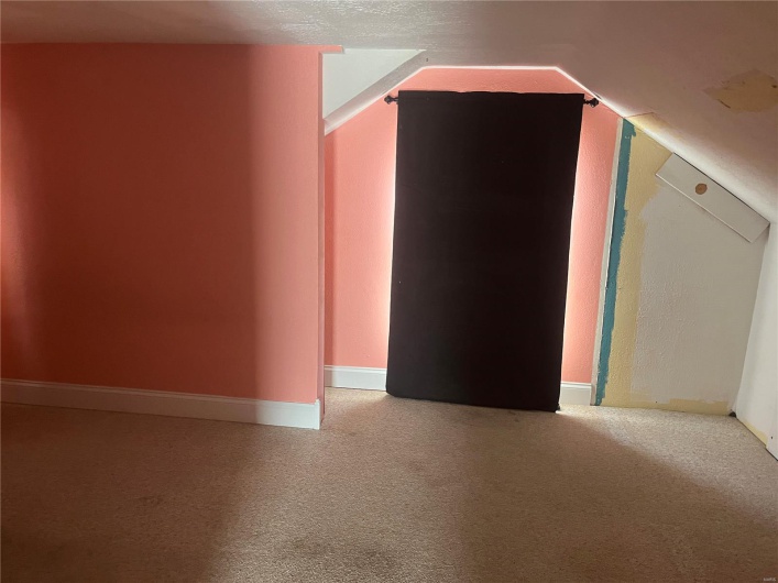 Bonus room featuring baseboards, lofted ceiling, and carpet