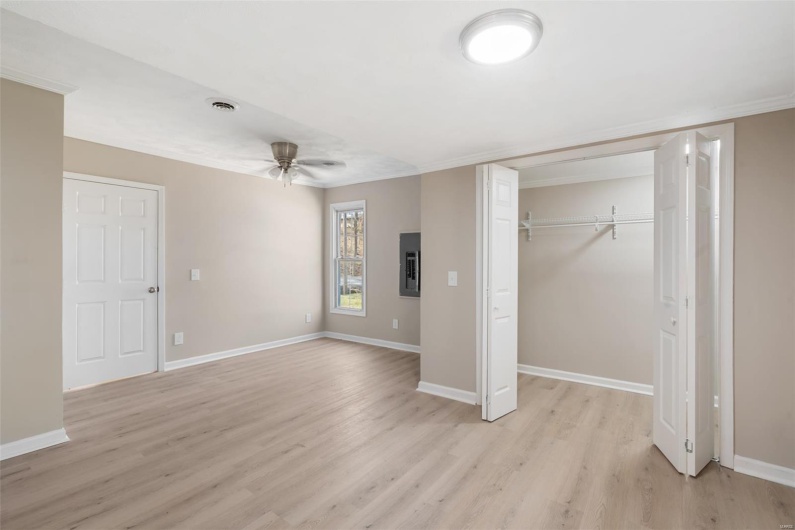 Unfurnished bedroom with light wood-style flooring, a closet, baseboards, and visible vents