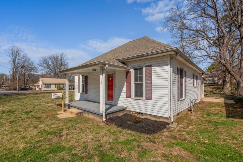 Bungalow-style house featuring a front lawn, crawl space, covered porch, and roof with shingles