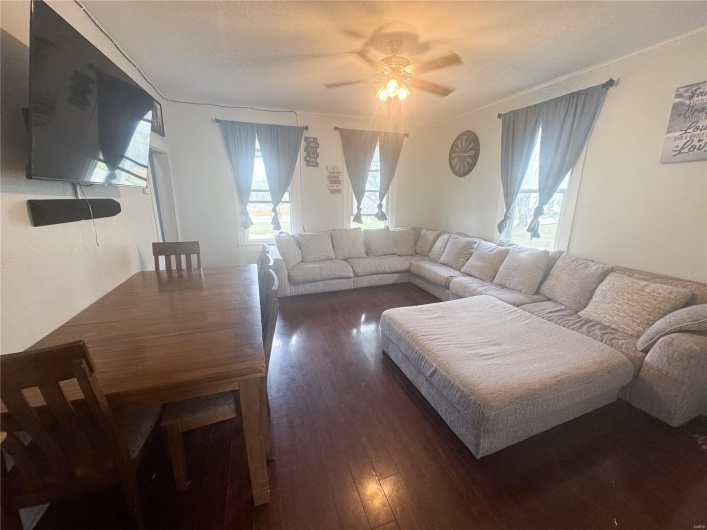 Living room featuring ceiling fan and hardwood / wood-style flooring