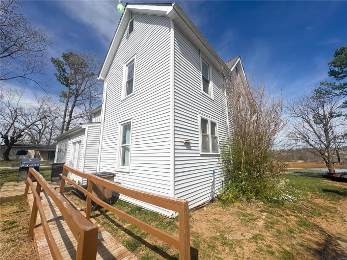 View of property exterior with a wooden deck