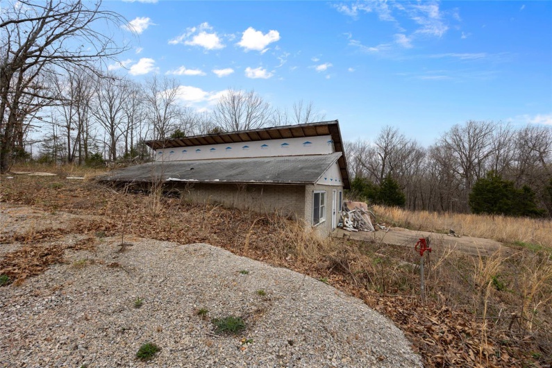 View of home's exterior with an outbuilding