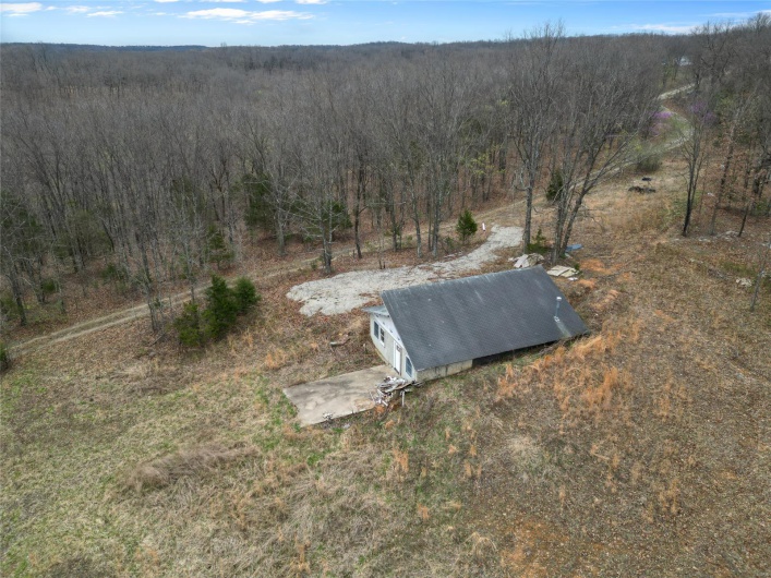 Drone / aerial view featuring a wooded view