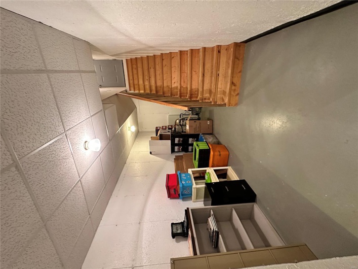 Finished below grade area featuring stairs and a paneled ceiling