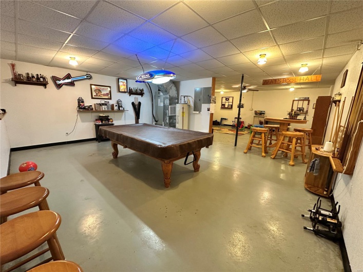 Playroom with baseboards, billiards, finished concrete floors, and a drop ceiling