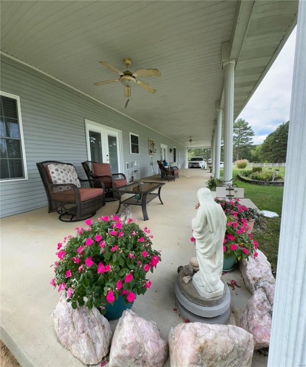View of patio featuring french doors and ceiling fan