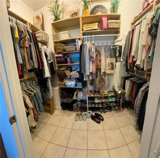 Spacious closet featuring tile patterned flooring