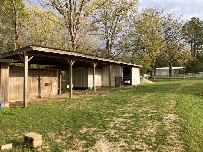 View of yard with fence, an outdoor structure, and a pole building