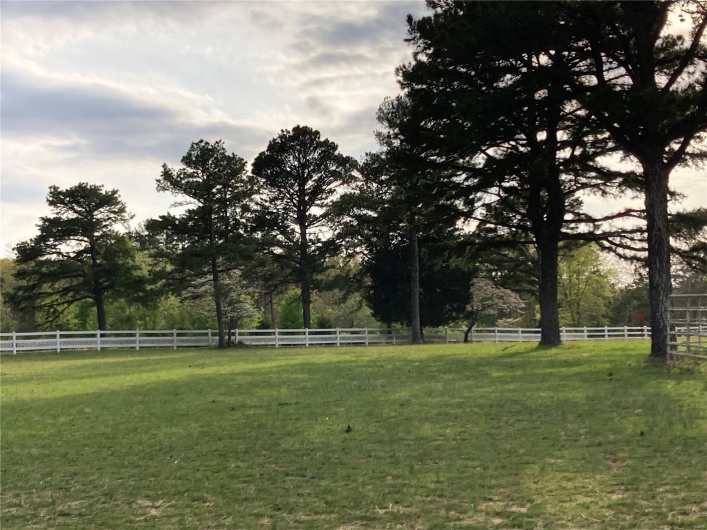View of yard with a rural view and fence