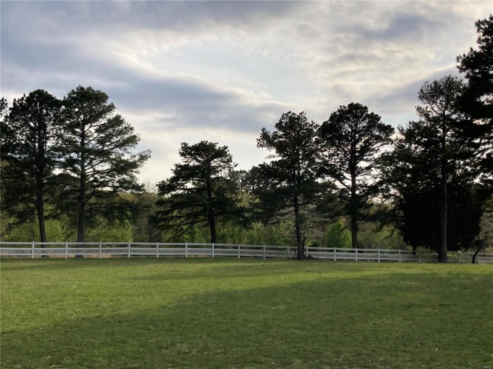 View of yard featuring fence and a rural view
